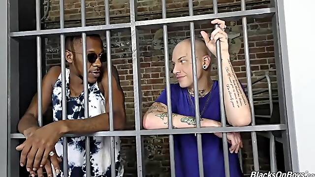 Tattooed white guy rides a black cock in prison