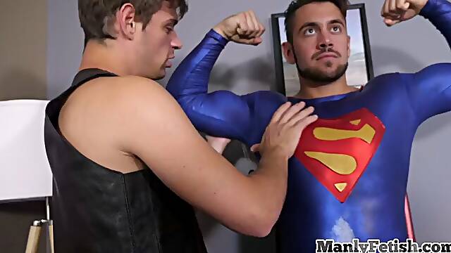 Superman jerks cock while getting pumped by erotic couple