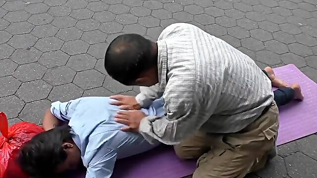 Topless man with his belly button and nipples pierced massaged