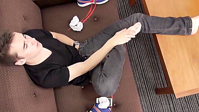 Perverted twink licks his feet and strokes his thick cock