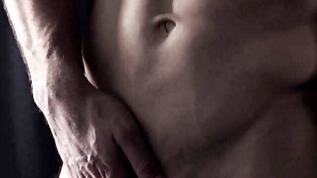 Hairy hunk Chuck Conrad works his massive dick with his two hands after flexing
