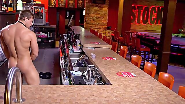Buff stud strips nude to masturbate passionately behind bar