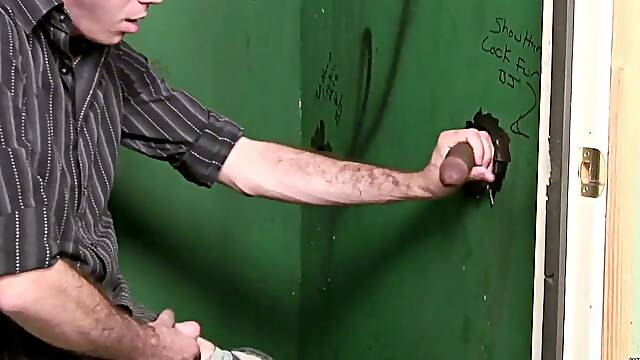 White dude sucks big black cock in a glory hole video