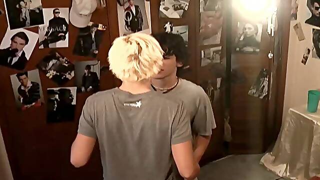 Cute gay guy with blonde hair enjoying a cock suck on his bed