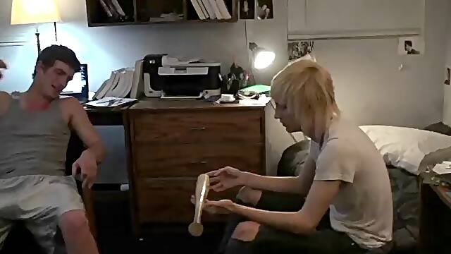 Skinny gay guy with long blonde hair sucking a stranger's cock