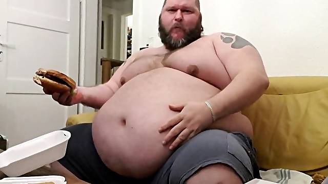 Superchubby SOC - large guy slurping a immense burger & onion rings