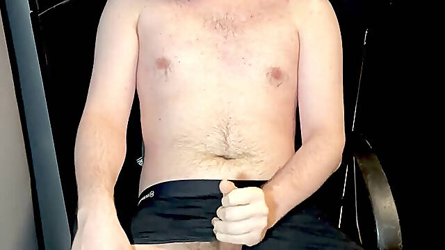 A fur covered man jerks off his erect cock and cums on his hairy torso