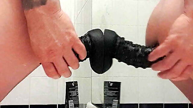 Carl cagedwarrior takes huge BBC dildo in hotel bathroom with mirror reflection 