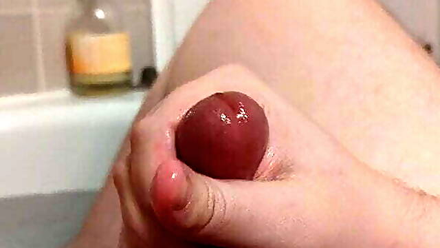 Cub shooting cum in the bath before smearing it all over.