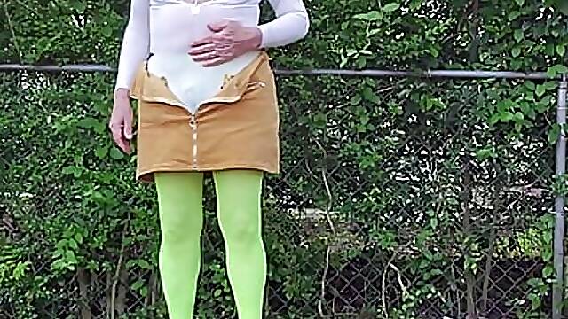 Gay crossdress tease, outdoors ground humping in pantyhose, black bra, miniskirt.