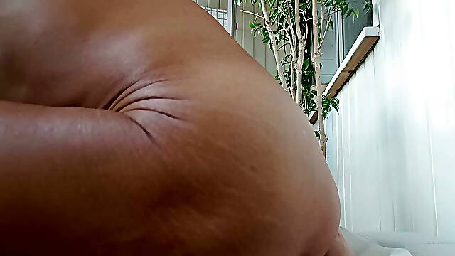 Anal masturbation while looking out the window at passers-by.