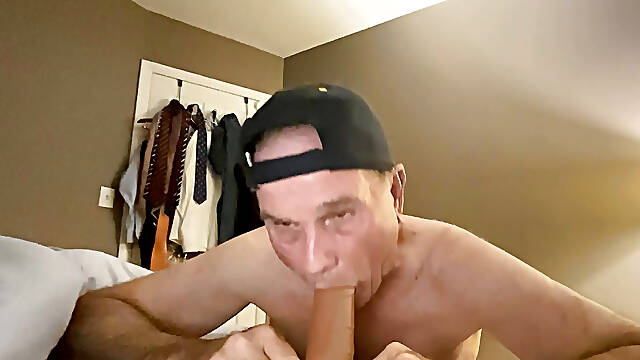 Bikeman exposed sucking dildo