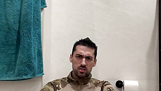 Military guy two hands jerks his meat