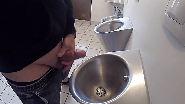 I was pissing and jerking off my cock sensually at the urinal in a public restroom, and then someone came.