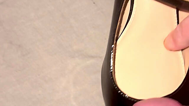 Cumming on black patent heels