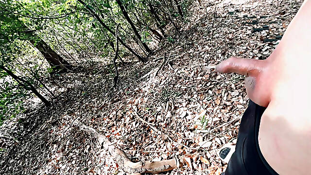 A boy with a small foreskin pees a huge stream outdoors