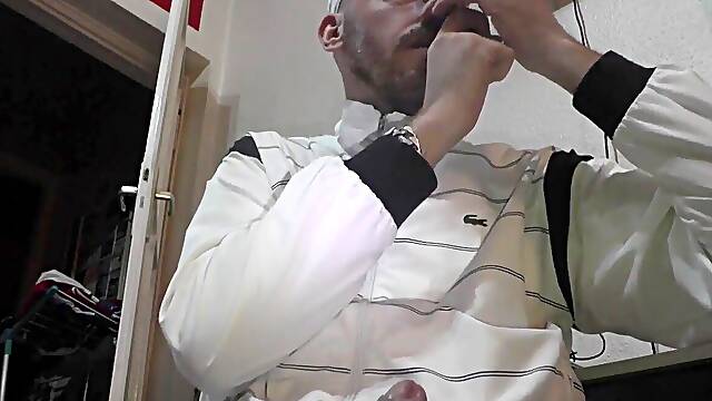 Naughty guy in Lacoste shirt urinates while jerking off with a rock-hard cock